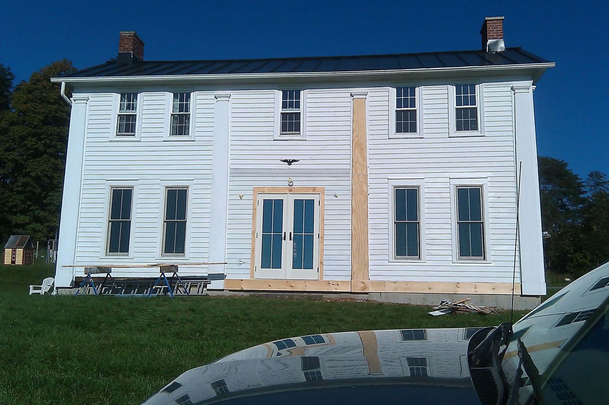 New exterior door, replacement windows, and siding repair by Ravencraft