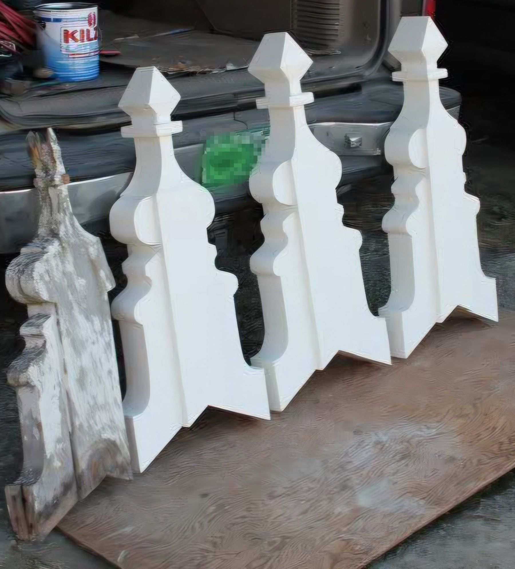 Hand-replicated Victorian gable roof peak ornament next to the original weathered piece