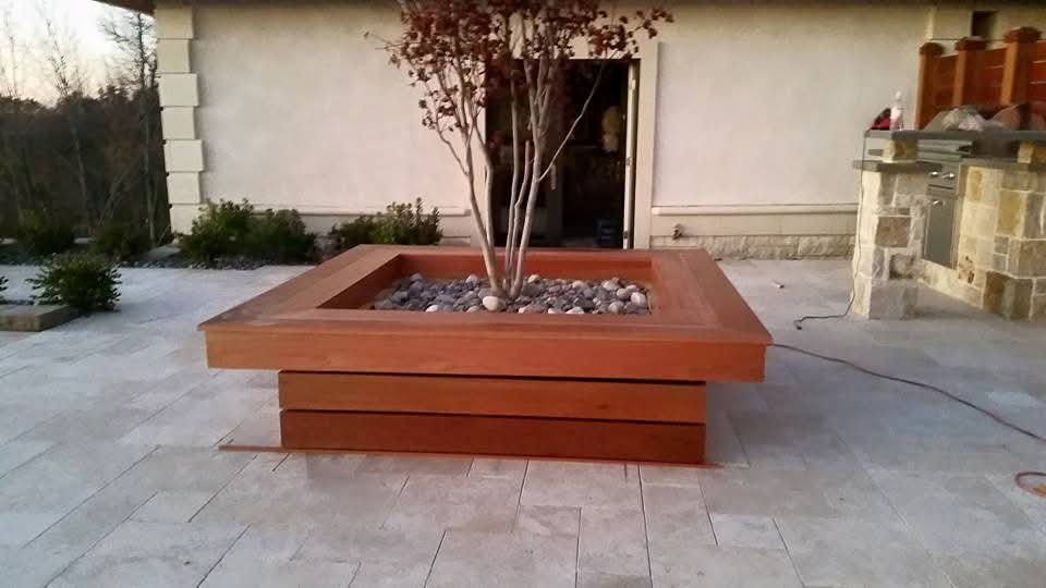 Finished mahogany planter box on stone patio
