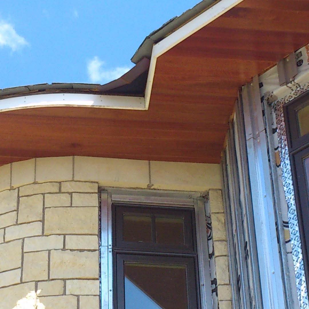 Curved mahogany soffit detail on new construction home